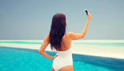 Image showing young woman taking selfie with smartphone