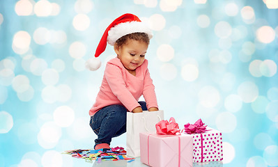 Image showing happy little baby girl with christmas presents