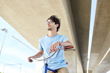 Image showing young hipster man riding fixed gear bike