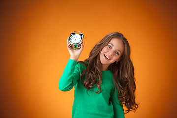 Image showing The cute cheerful little girl on orange background