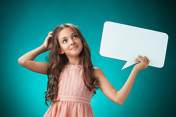 Image showing The cute cheerful little girl on orange background