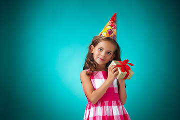 Image showing The cute cheerful little girl on blue background