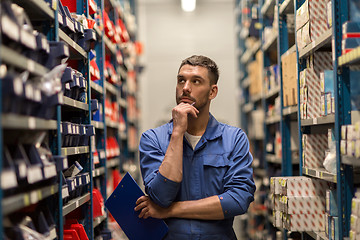 Image showing auto mechanic with clipboard at car workshop