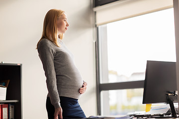 Image showing pregnant businesswoman with computer at office