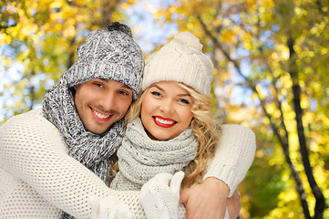 Image showing happy couple in warm clothes over autumn