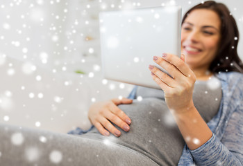 Image showing close up of pregnant woman with tablet pc at home