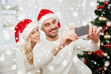 Image showing couple taking selfie with smartphone at christmas