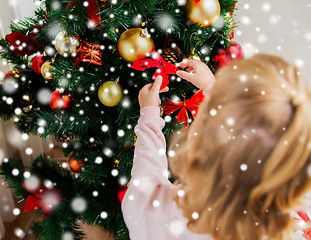 Image showing close up of child decorating christmas tree