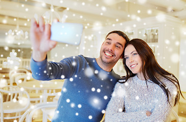 Image showing couple taking smartphone selfie at cafe restaurant