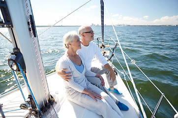 Image showing senior couple hugging on sail boat or yacht in sea