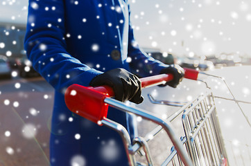 Image showing close up of woman with shopping cart on street