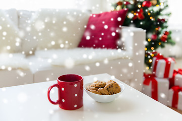 Image showing close up of christmas cookies and red cup on table