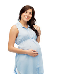 Image showing happy pregnant woman touching her big belly