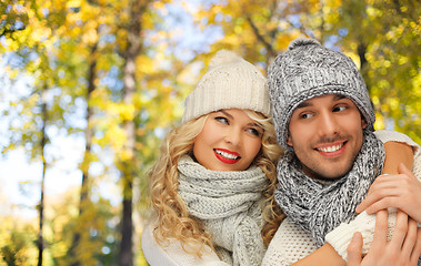 Image showing happy couple in warm clothes over autumn