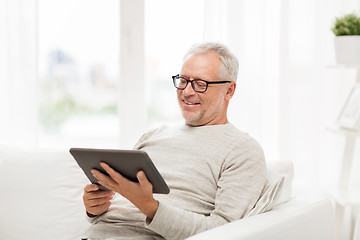 Image showing senior man with tablet pc at home