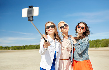 Image showing group of smiling women taking selfie on beach