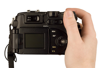 Image showing Digital Camera photo in a hand isolated on withe background. lcd screen and background can be easily edited