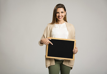 Image showing Woman showing something on a chalkboard