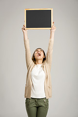 Image showing Woman showing something on a chalkboard