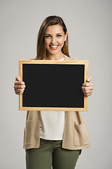 Image showing Woman showing something on a chalkboard