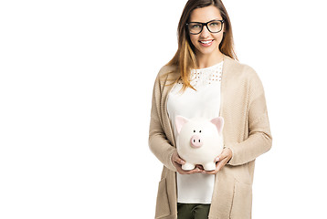 Image showing Woman holding piggybank