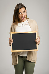 Image showing Woman showing something on a chalkboard