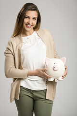 Image showing Woman holding piggybank