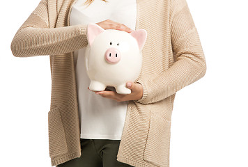 Image showing Woman holding piggybank