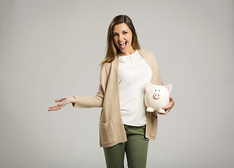 Image showing Woman holding piggybank