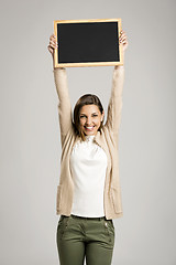 Image showing Woman showing something on a chalkboard