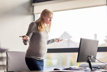 Image showing pregnant businesswoman stressing at office work