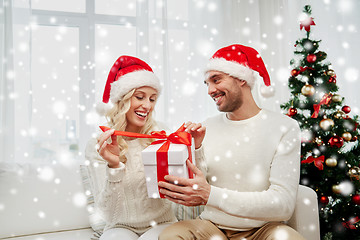 Image showing happy couple at home with christmas gift box