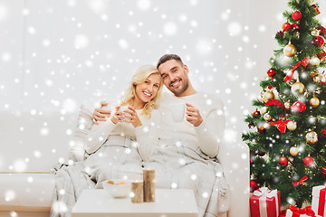 Image showing happy couple at home with christmas tree