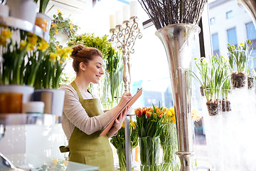 Image showing florist woman with clipboard at flower shop