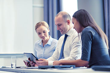 Image showing smiling business people with tablet pc in office