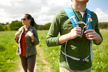 Image showing close up of couple with backpacks hiking outdoors