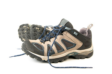 Image showing clothes hiking boots or shoes isolated on a withe background made of leather and waterproof and breathable membrane