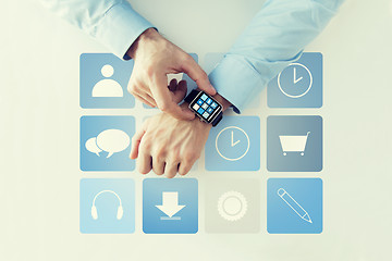 Image showing hands with application icons on smart watch