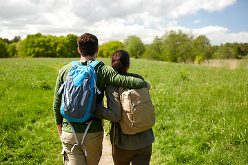 Image showing happy couple with backpacks hiking outdoors