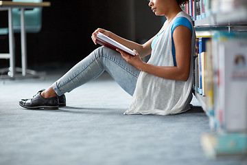 Image showing happy african student girl reading book at library