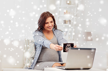 Image showing pregnant woman with ultrasound image and laptop