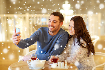 Image showing couple taking smartphone selfie at cafe restaurant