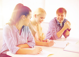 Image showing smiling students with notebooks at school