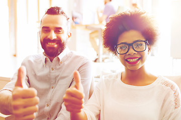 Image showing happy creative team in office showing thumbs up