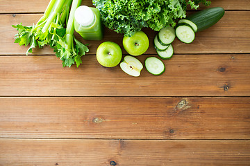 Image showing close up of bottle with green juice and vegetables