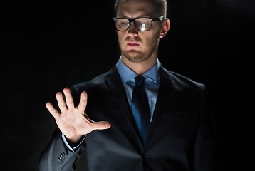 Image showing close up of businessman touching virtual screen