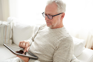 Image showing senior man with tablet pc at home