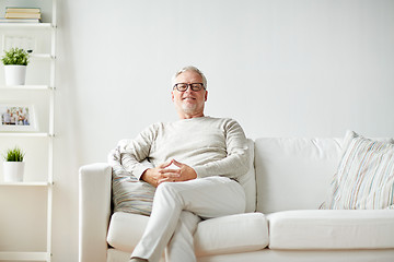 Image showing smiling senior man in glasses sitting on sofa