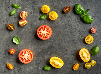 Image showing various colorful tomatoes and basil leaves