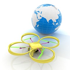 Image showing Quadrocopter Drone with Earth Globe and remote controller on a w